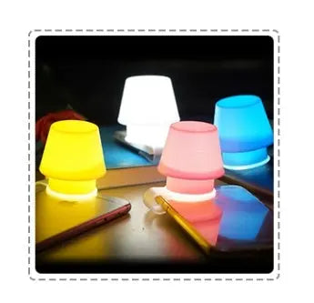 Mabor phone holder lamp glowing softly in a cozy bedroom setup